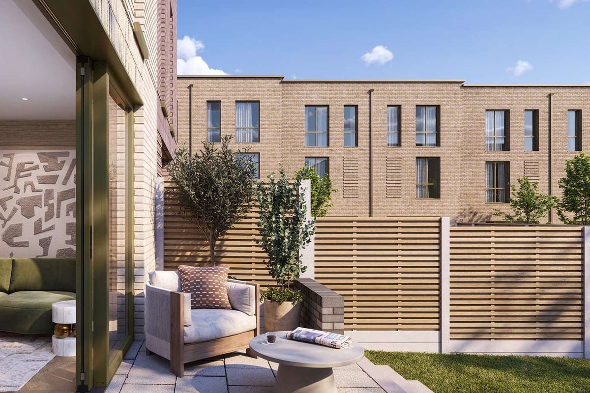 Computer-generated image of a townhouse garden: a paved terrace with lounge chairs, a lawn and slatted timber fencing, the living room open behind